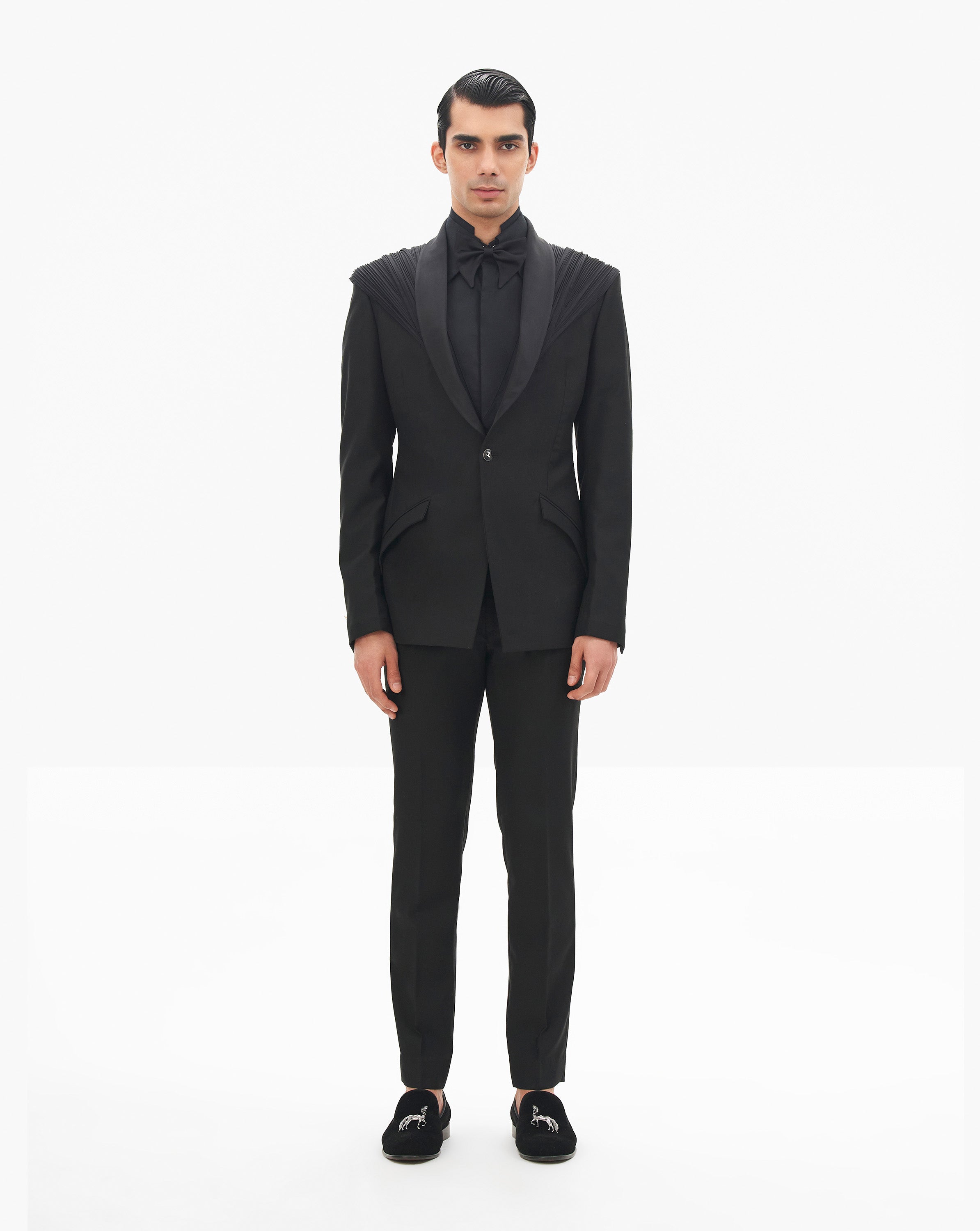 Model wearing a black tuxedo by Gaurav Gupta
