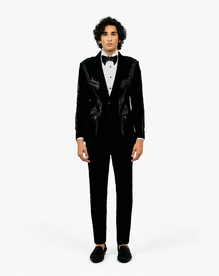 Man wearing a black tuxedo with a white shirt and black bow tie by Gaurav Gupta