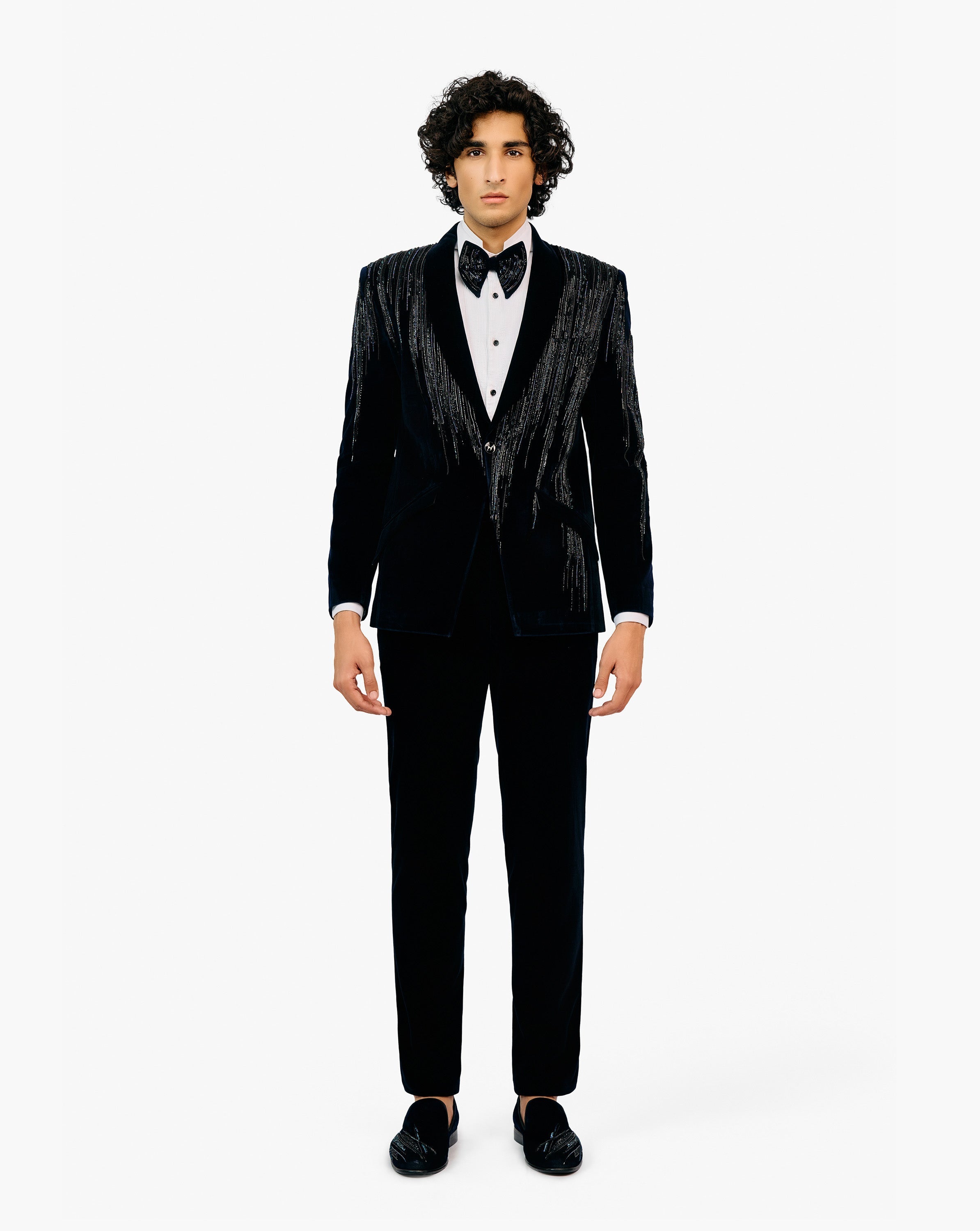 Man in a black tuxedo with bow tie by Gaurav Gupta
