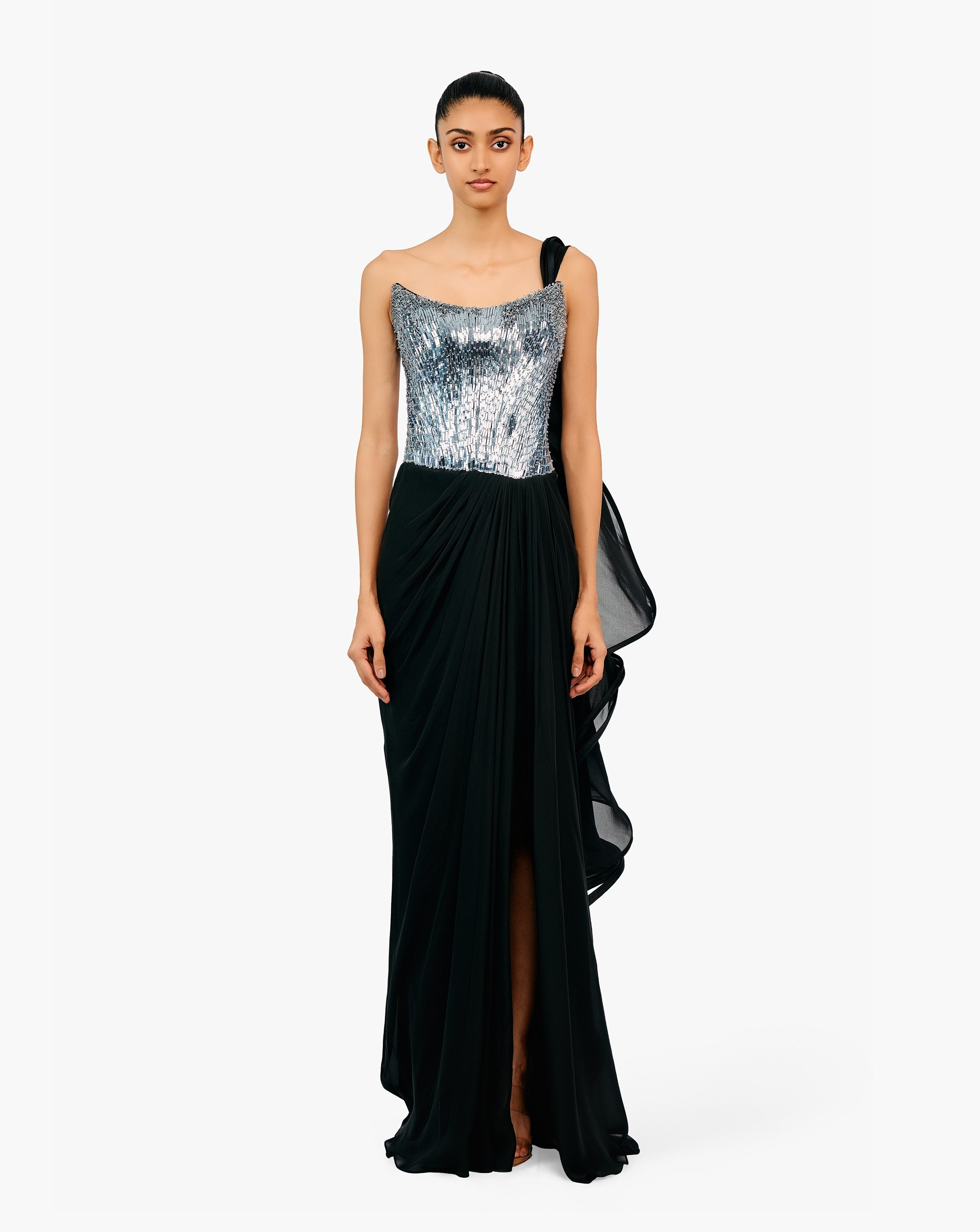 Woman wearing a silver sequin and black draped gown by Gaurav Gupta
