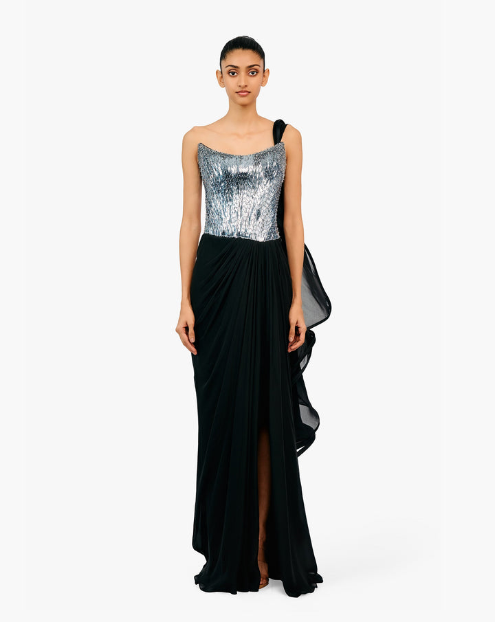 Woman wearing a silver sequin and black draped gown by Gaurav Gupta