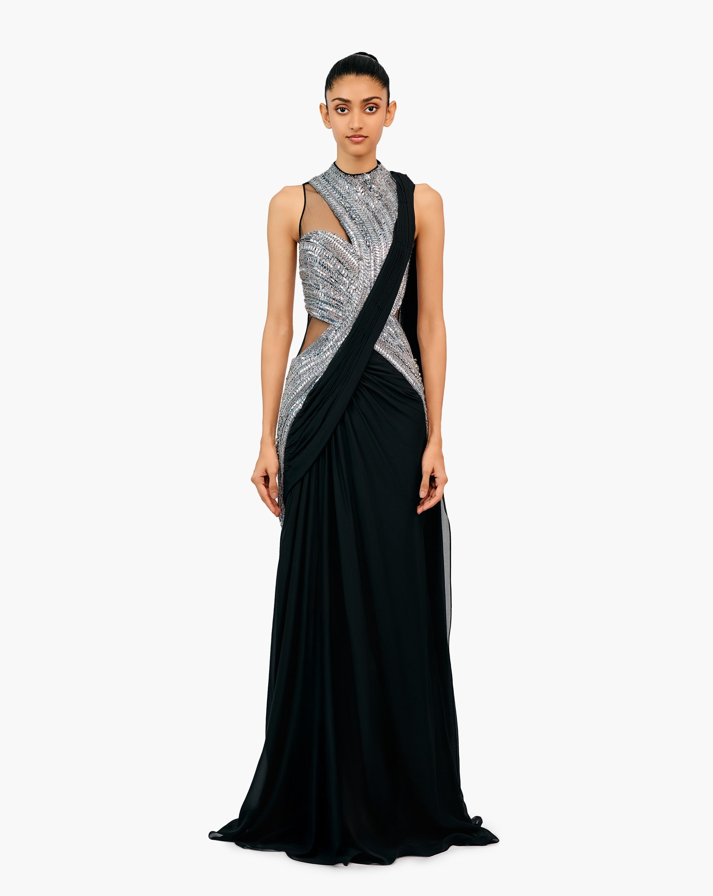 Woman wearing a black and silver embellished draped gown by Gaurav Gupta