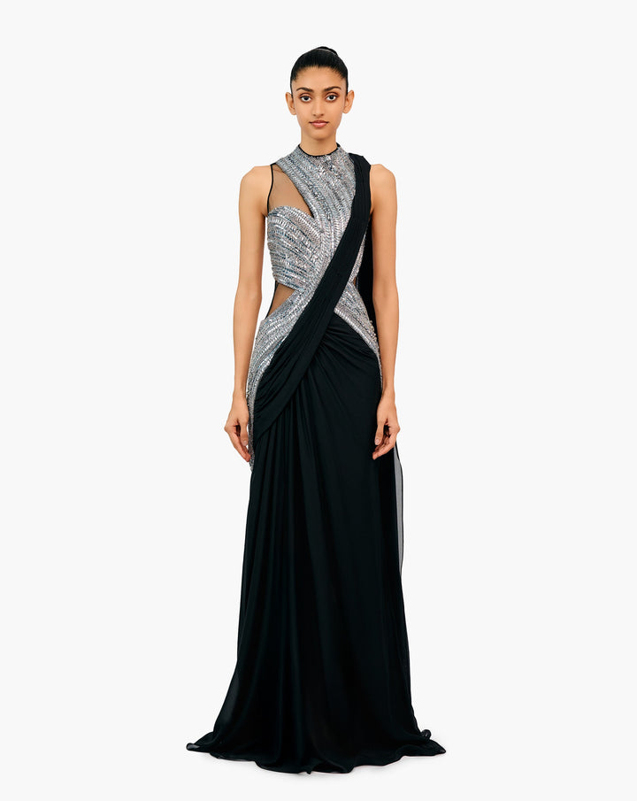 Woman wearing a black and silver embellished draped gown by Gaurav Gupta