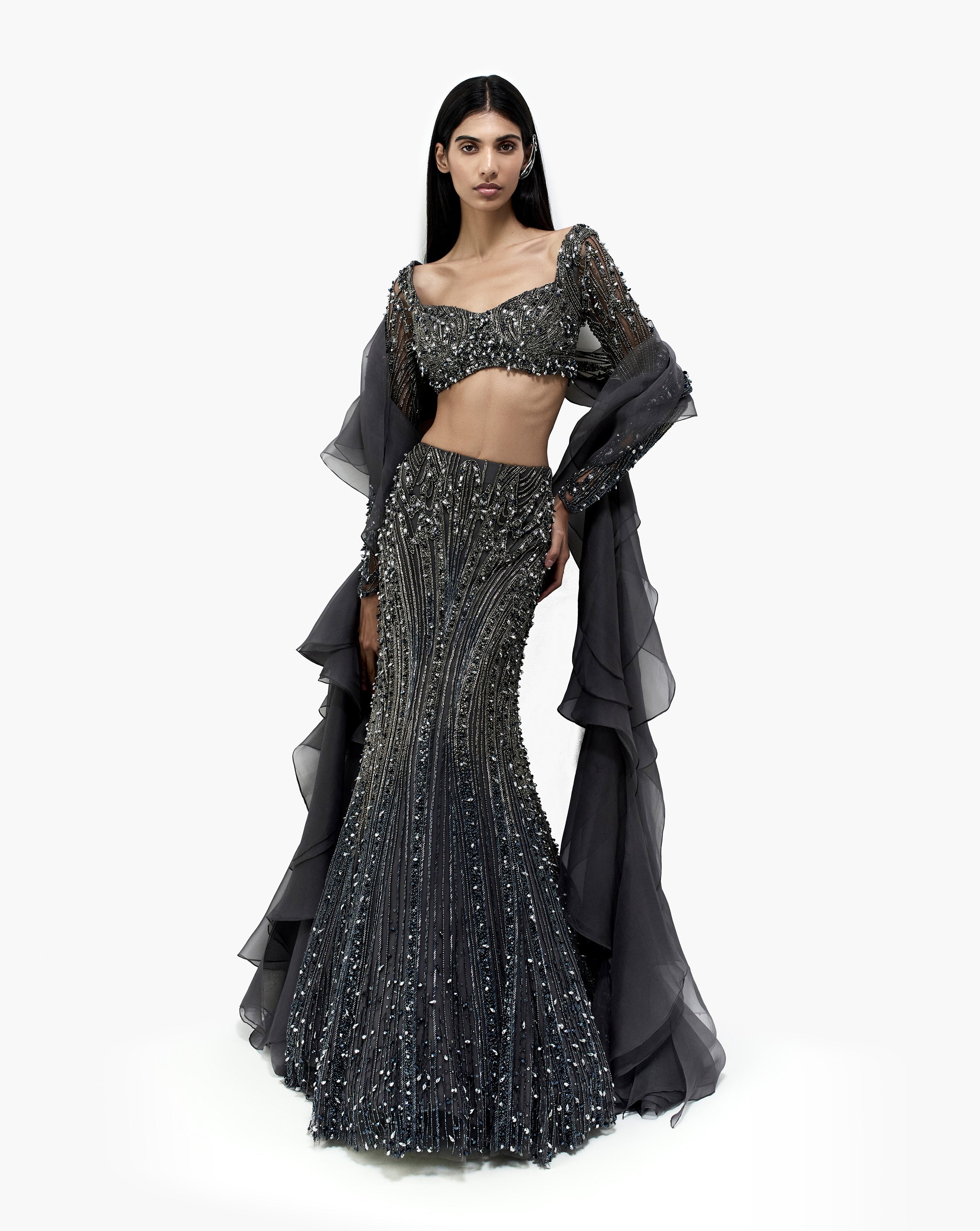 Woman wearing silver embroidered dress by Gaurav Gupta