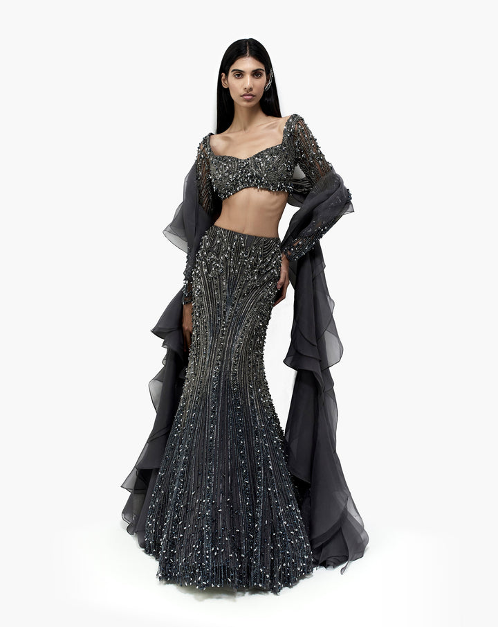 Woman wearing silver embroidered dress by Gaurav Gupta