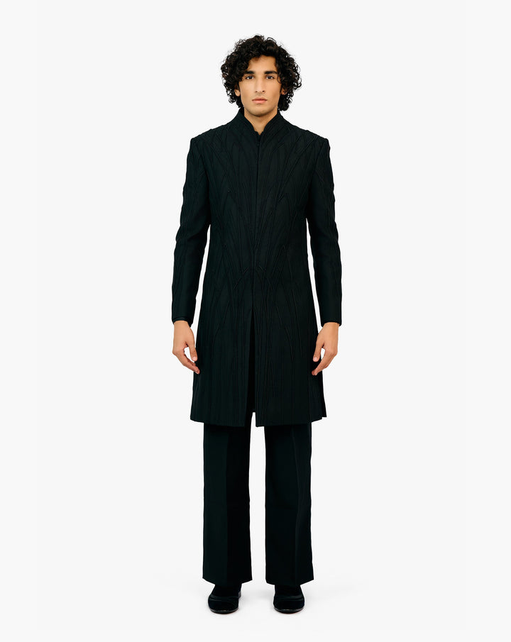 Model wearing black suit by Gaurav Gupta