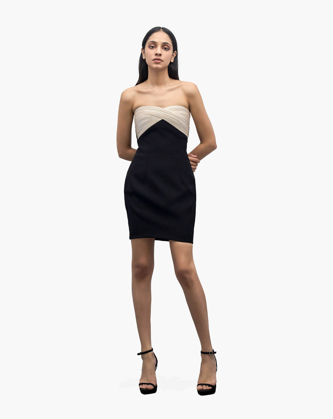 Model in a strapless black dress with a cream colored bodice by Gaurav Gupta