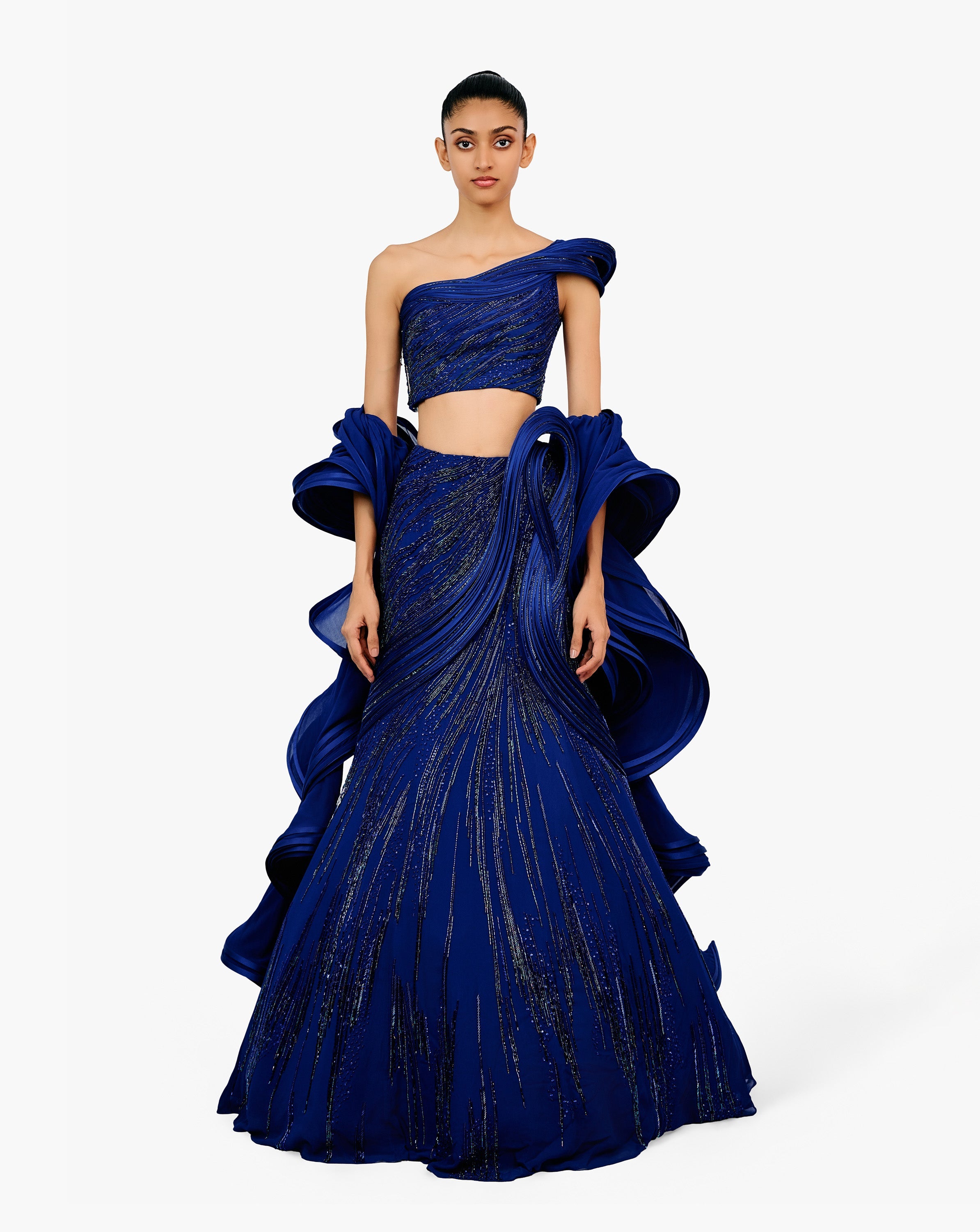 Woman in blue lehnga with flared dupatta by Gaurav Gupta