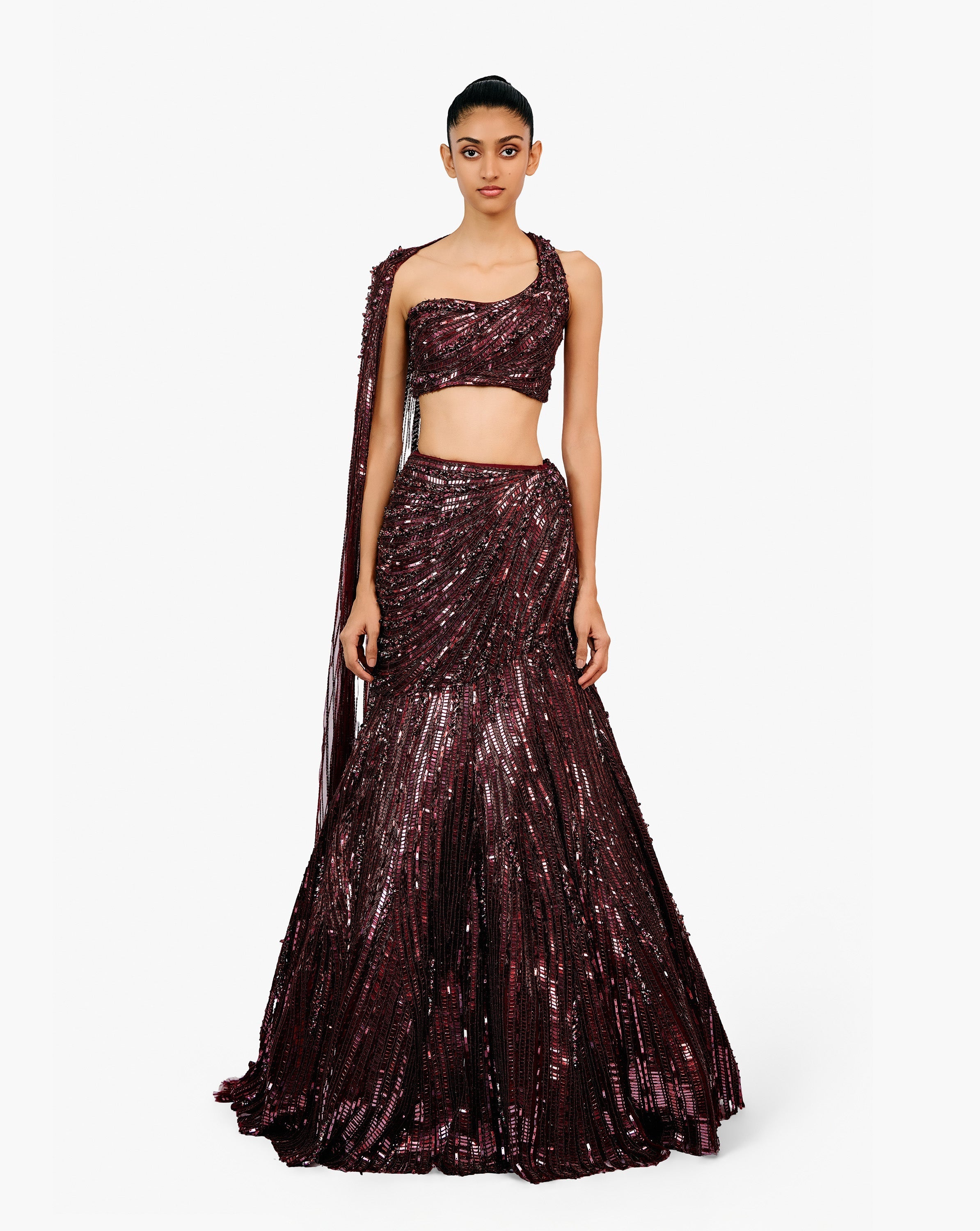 Woman wearing a dark purple embroidered dress by Gaurav Gupta