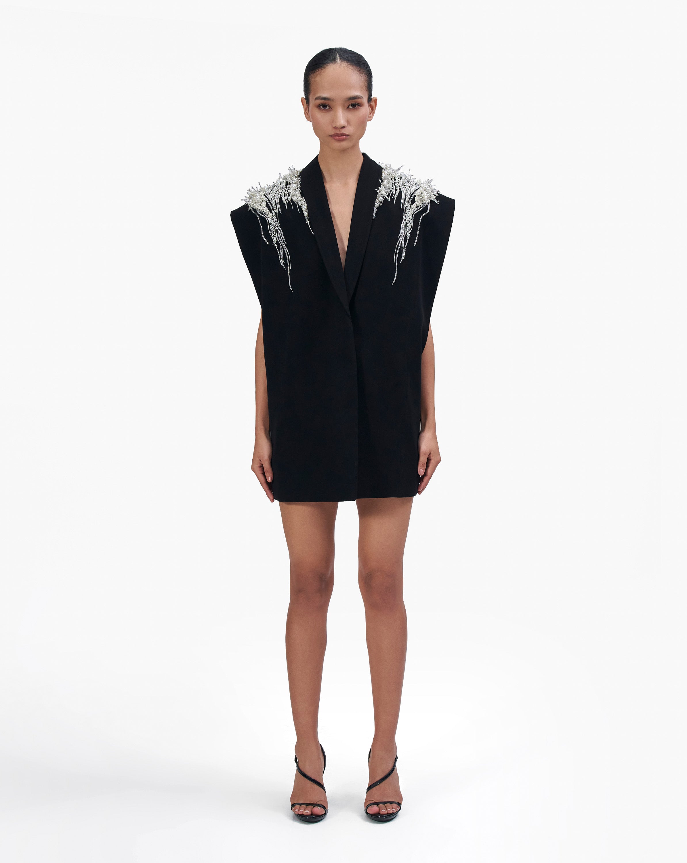 Model wearing a black outfit with white embroidery by Gaurav Gupta